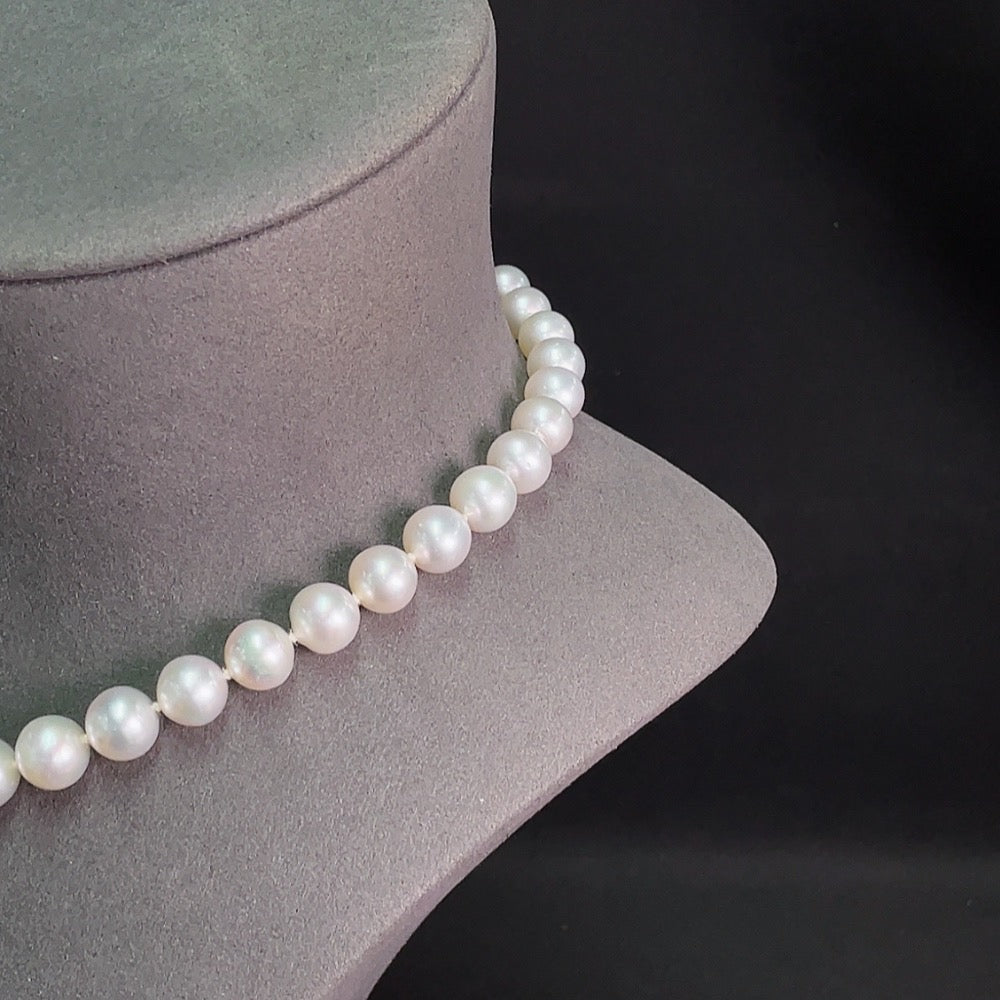 Saltwater pearl strand necklace with 14K gold clasp, elegant jewelry piece featuring lustrous pearls and gold accents.