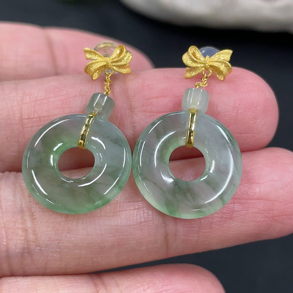Pair of Jadeite donut stud earrings with 18k gold settings, featuring green jade stones, shown on a plain background