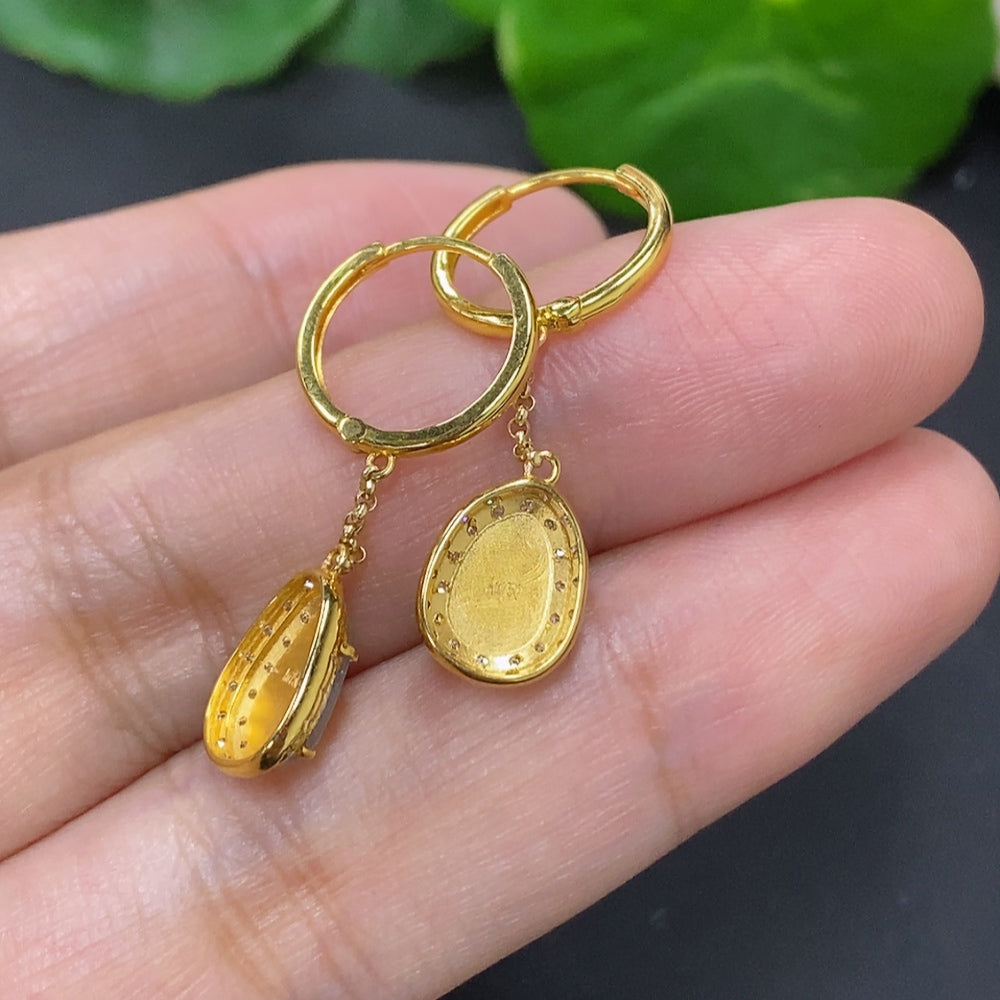 Jadeite auspicious bean earrings set in 18K gold with diamond accents, featuring delicate jade beads and gold hooks.
