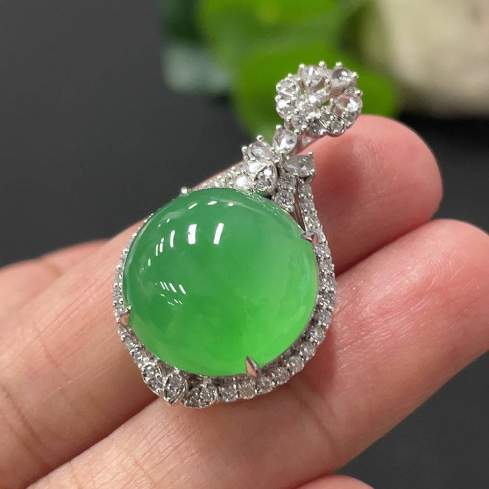 Jadeite cabochon pendant with 18K gold setting, diamond accents, showcasing a polished green jade stone in a elegant jewelry design