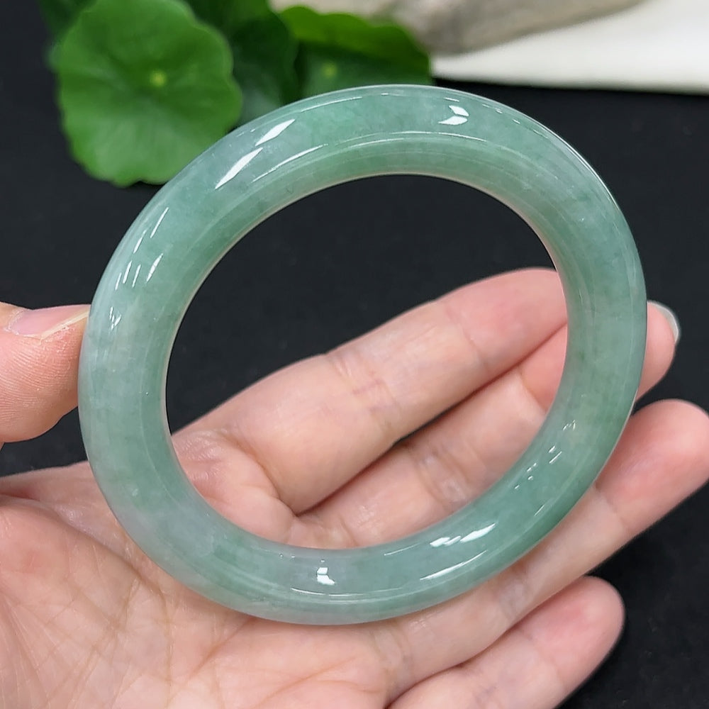 HKHQ jadeite round bangle, size 57.7, 68.6g, showcasing smooth, polished green jadeite bracelet with a glossy finish.