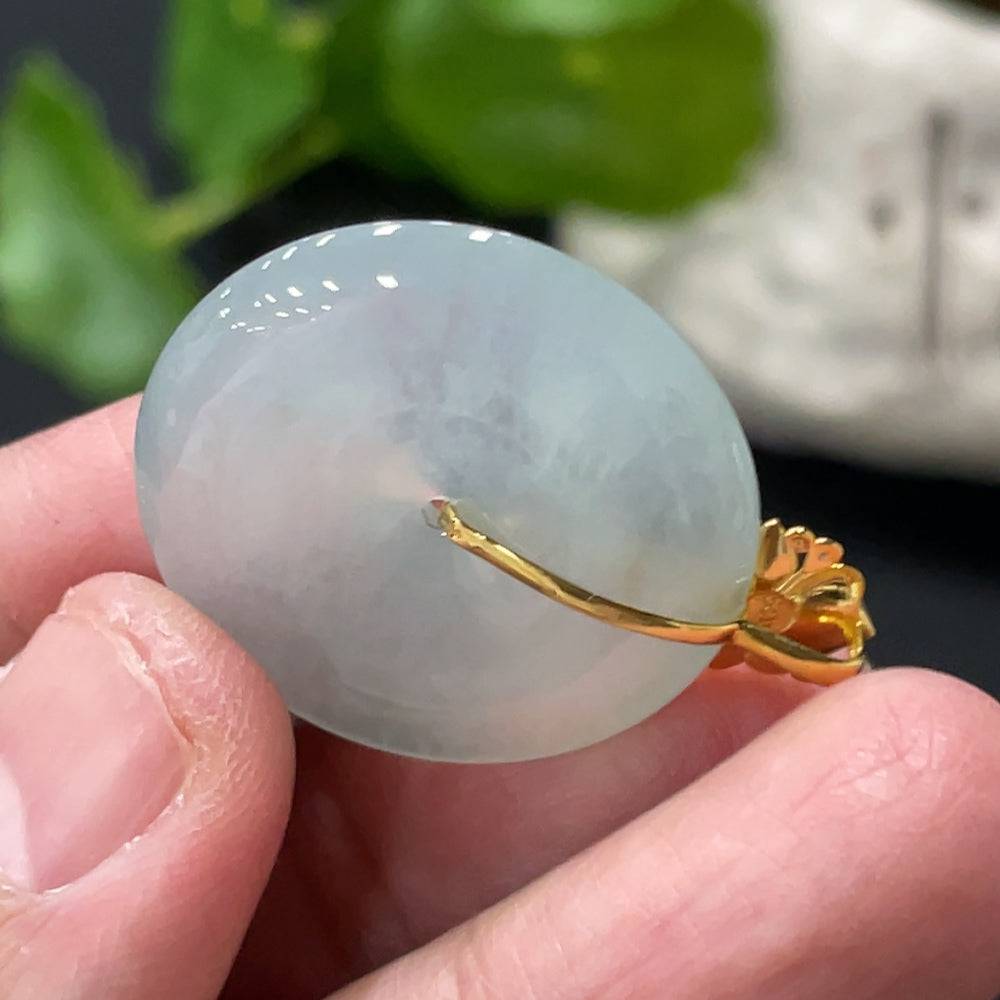 Jadeite safety pendant with diamond accents, 18K gold bail, weighing approx. 6.87g, featuring a polished green jade gemstone.
