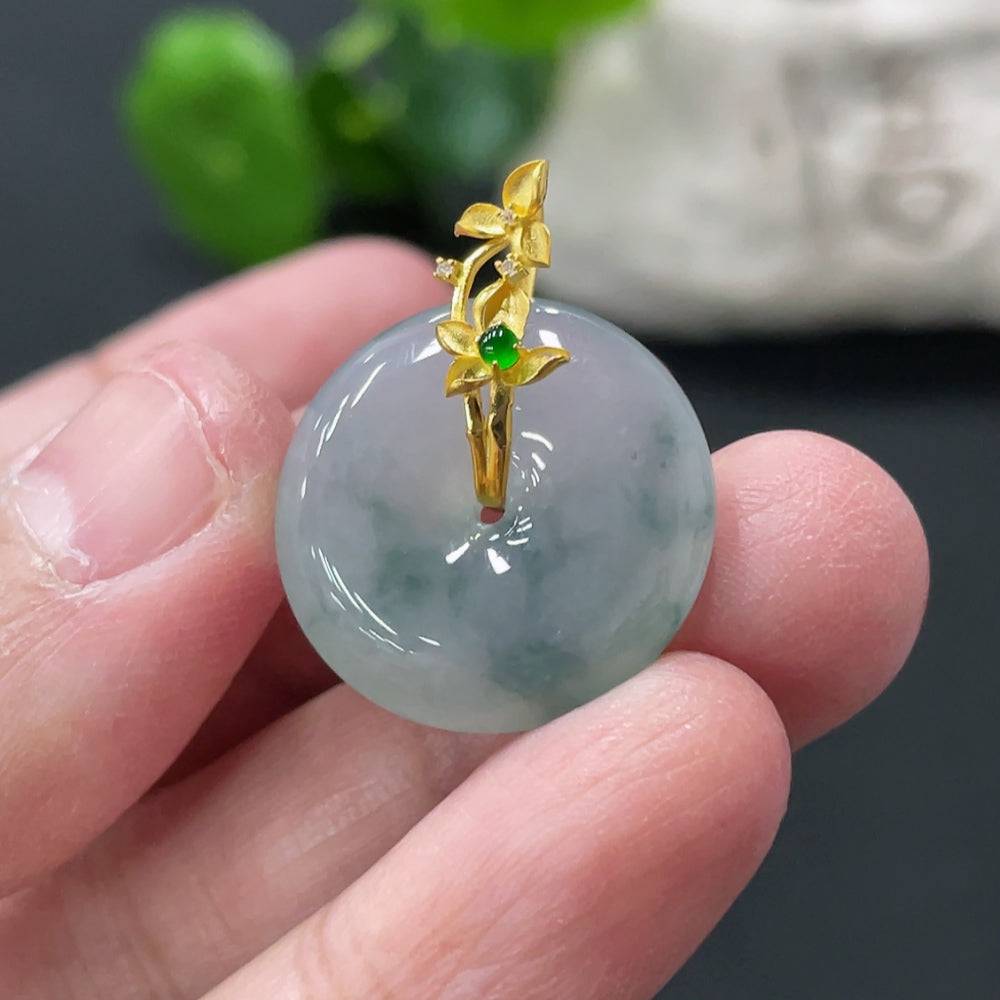 Jadeite safety pendant with 18k gold clasp, featuring smooth green jade stone and a secure clasp, weighing approximately 4.58 grams.