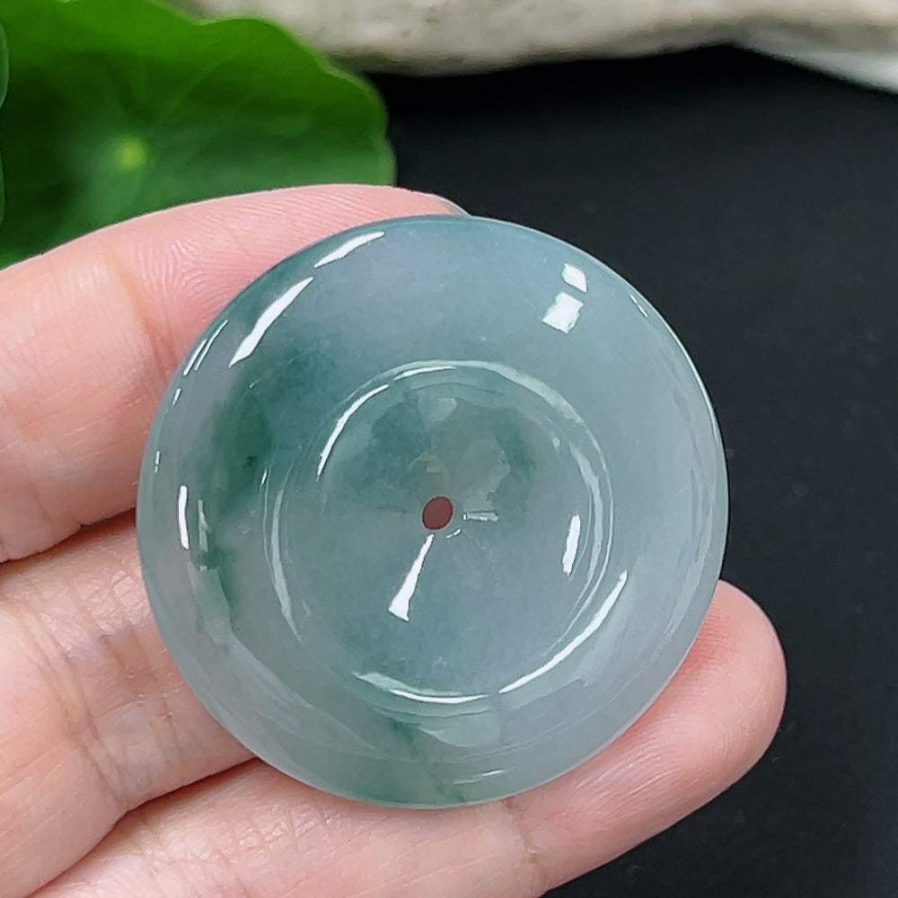 Jadeite Peace Knot pendant with intricate design, weighing approximately 18.9 grams, crafted by HKHQ, shown on a neutral background.