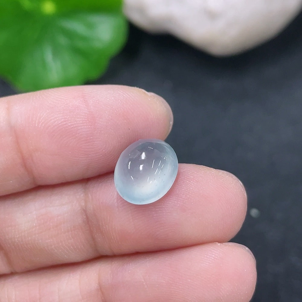 Jadeite cabochon jewelry piece from HKHQ, showcasing a smooth, polished green gemstone with natural color variations.