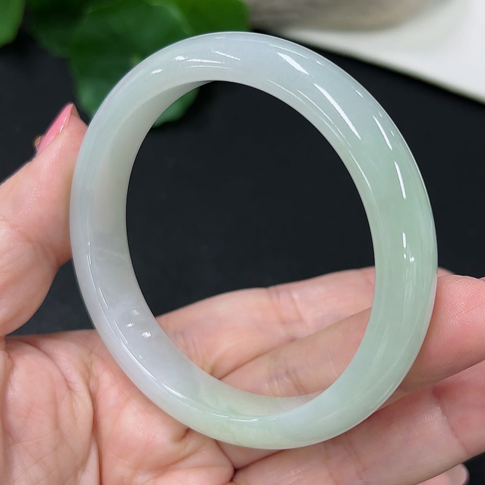 HKHQ jadeite round bangle in size 56, weighing 46.3g, showcasing smooth, polished green jadeite bracelet on a neutral background.
