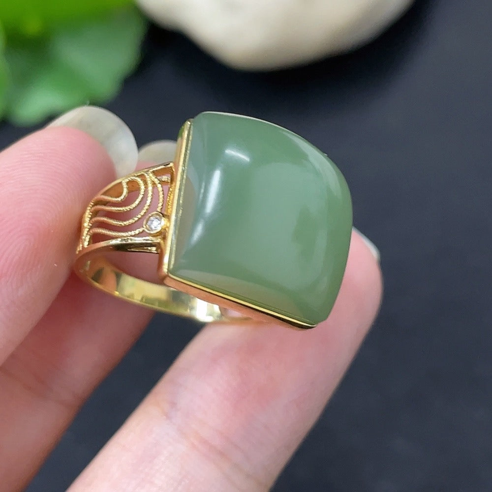 Elegant Hetian jade inlaid ring by HKHQ featuring diamond accents set in 18K gold, showcasing intricate craftsmanship and luxurious design.