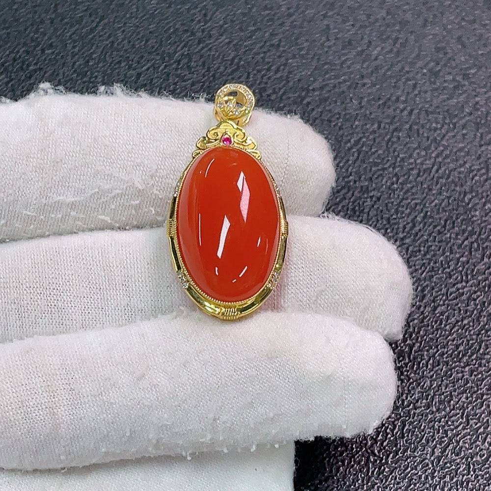 Red agate gemstone pendant with diamond accents, crafted by HUILIU HQ, featuring vibrant red stone and sparkling diamond details.