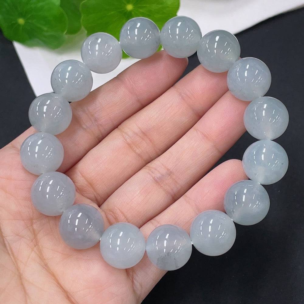Huiliu Jadeite bracelet, 12.8mm jade beads, natural green color, certified HUILIU HQ jewelry, close-up of the elegant jade bracelet.