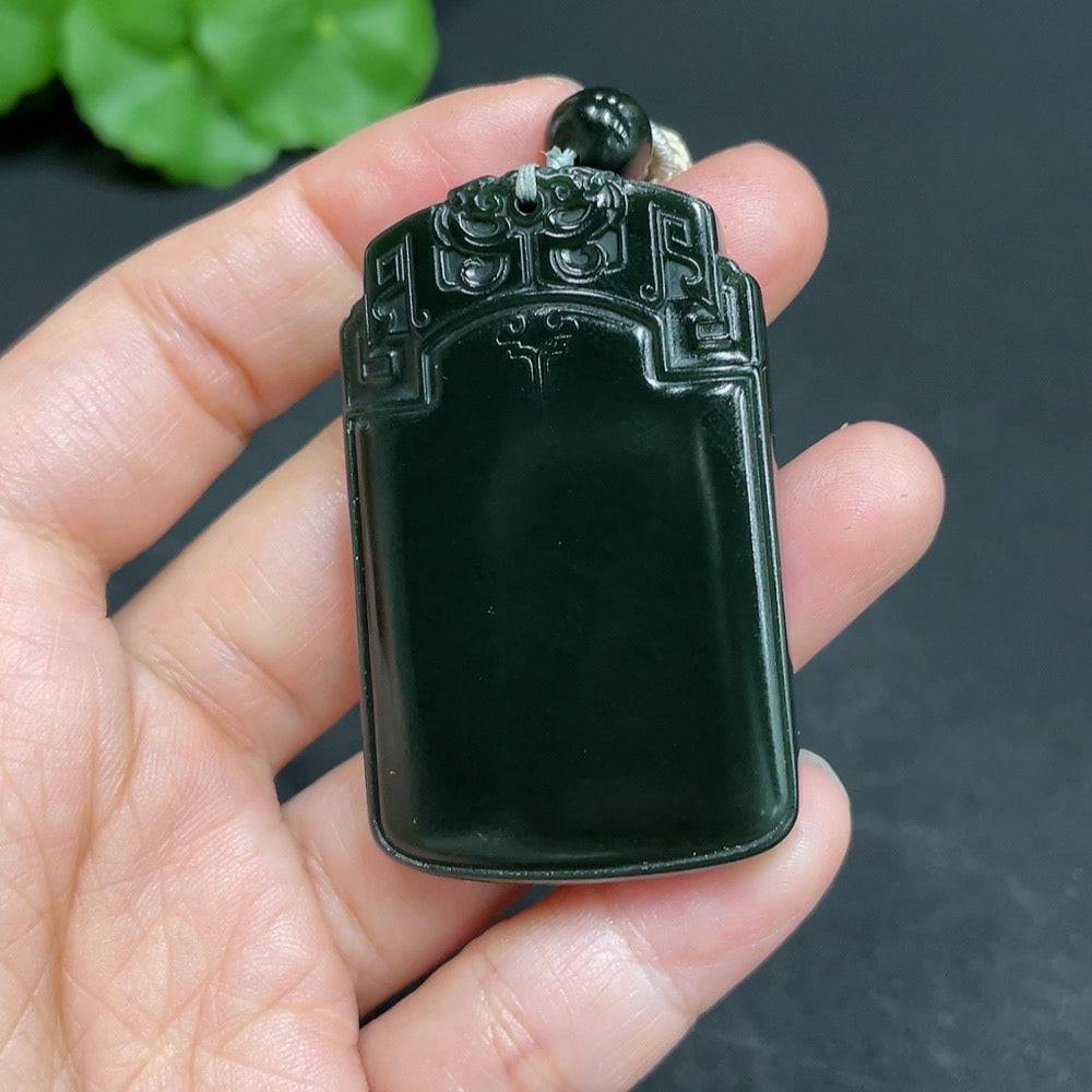 Huiliu certified Hetian jade pendant with antique plaque design and attached rope, showcasing intricate carving and smooth jade surface.
