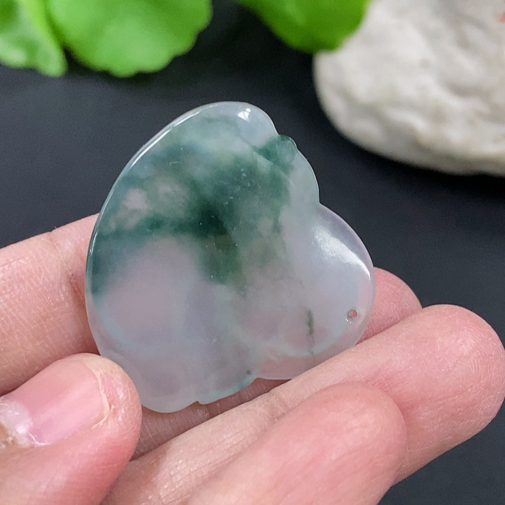 Jadeite Buddha pendant hanging on a cord, crafted from green jade, featuring detailed Buddha carving, by HKHQ.