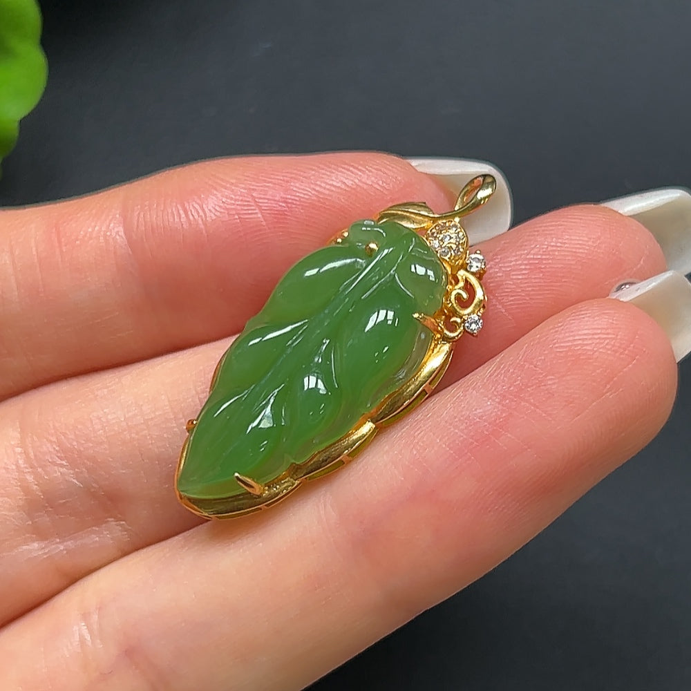 Green Hetian jade leaf pendant necklace with 18K gold setting, featuring a non-diamond design, by HKHQ.