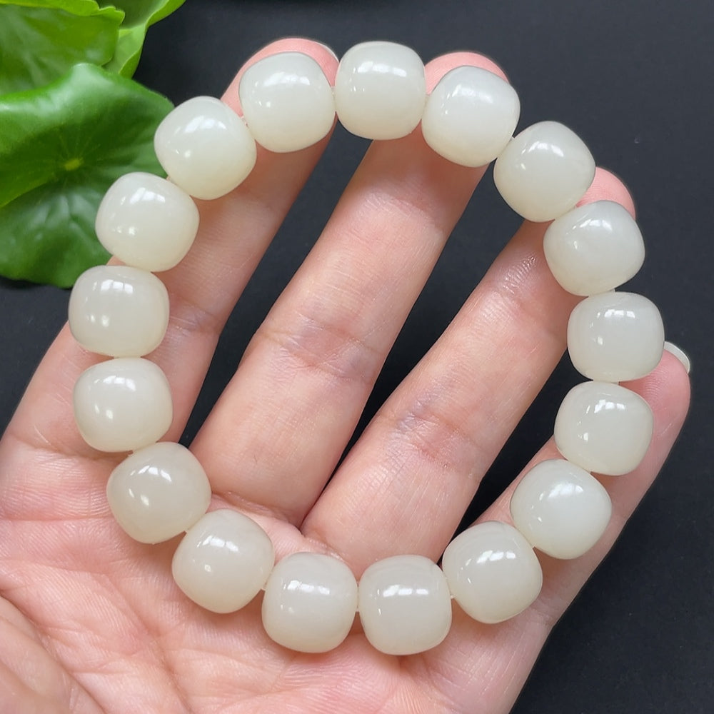 Hetian jade bracelet with 12mm beads from HKHQ, featuring a smooth, polished surface and natural green color.
