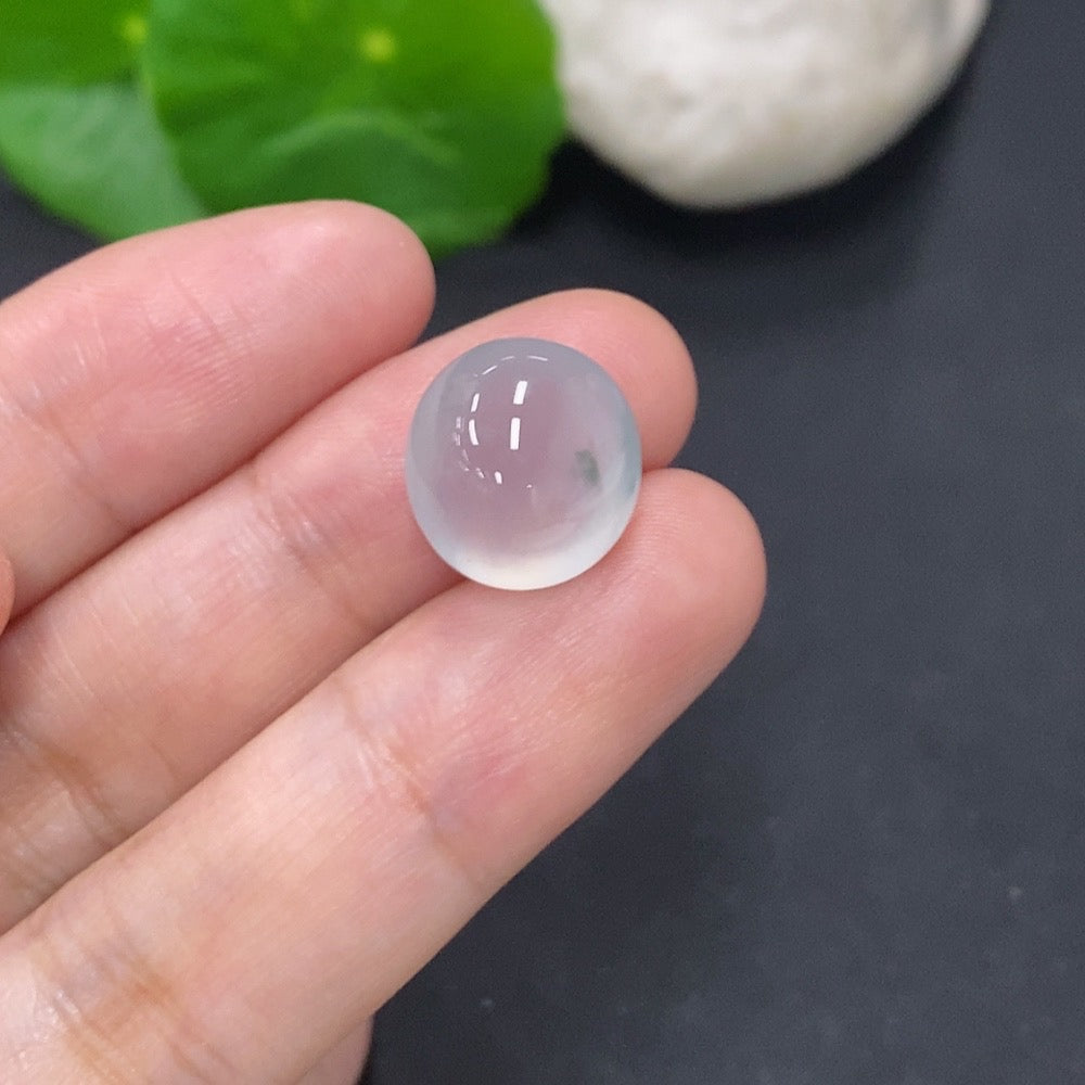 Natural jadeite cabochon jewelry piece, 2.2g, showcasing smooth, polished green gemstone with subtle variations in color and shine.