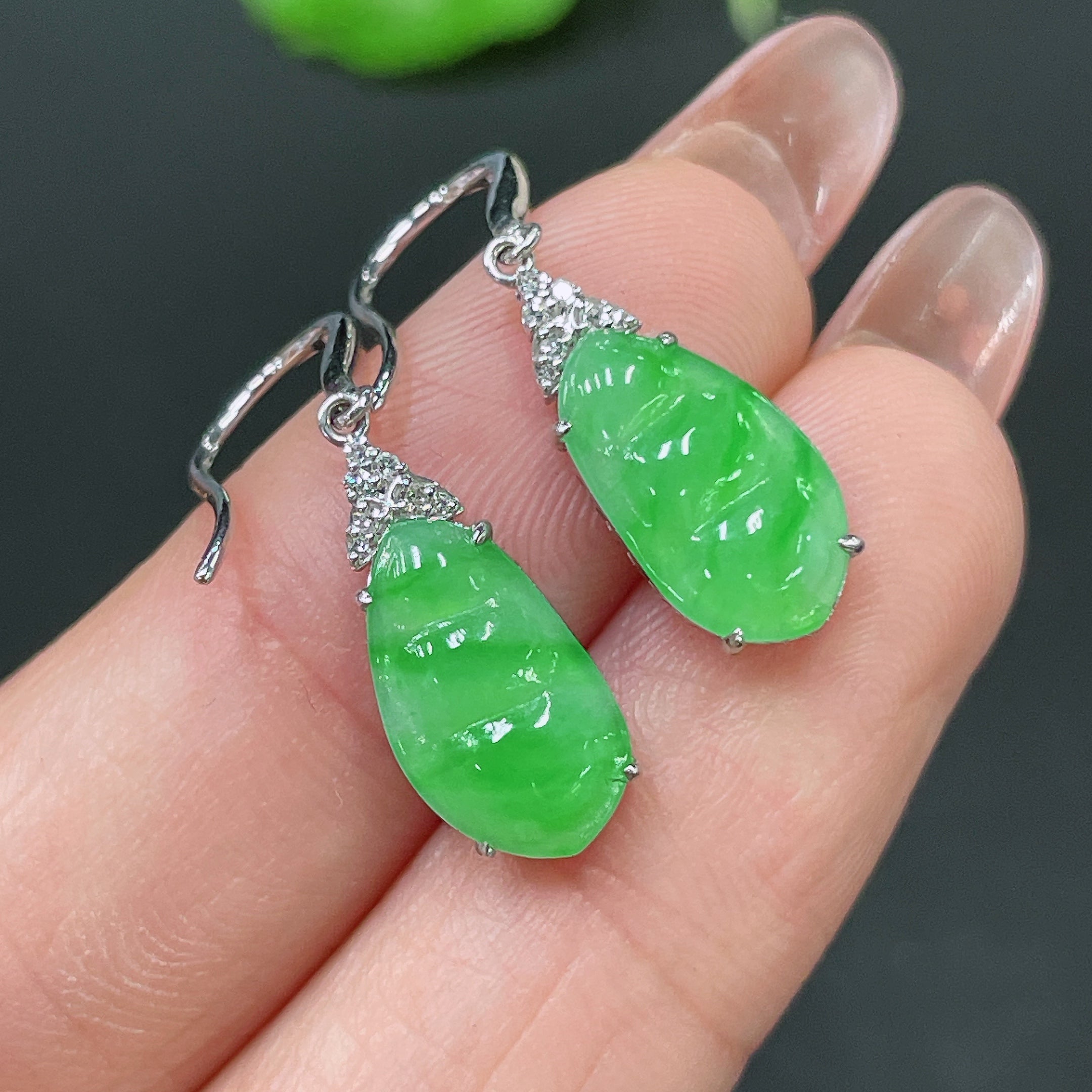 HUILIU HQ jadeite earrings with 18k gold inlay and diamond accents, shown in a close-up image highlighting the jewelry details.
