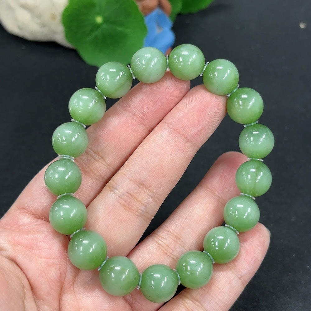 Green Hetian Jade bracelet from HKHQ featuring smooth, polished jade beads on a durable string, perfect for elegant jewelry.