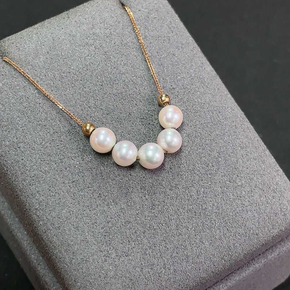 Seawater pearl necklace with 18k gold clasp, 5.6mm pearls, total weight 2.32g, by HKHQ, close-up of the elegant jewelry piece.