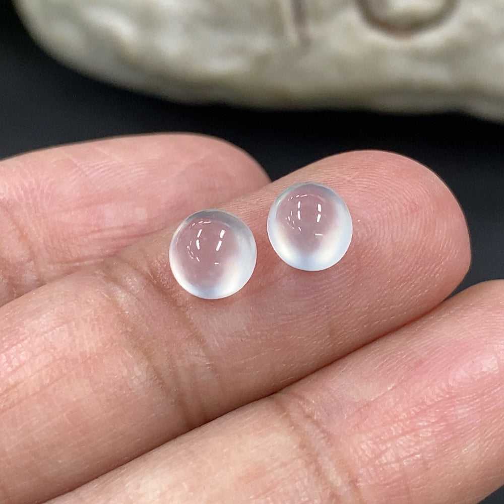 Jadeite cabochon jewelry piece from HKHQ, weighing 0.49g, showcasing smooth, polished green gemstone with natural luster and rounded shape.