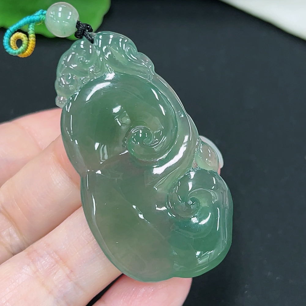 Jadeite Ruyi pendant from HKHQ featuring a smooth, polished jade piece with intricate carvings, weighing approximately 13.4 grams.