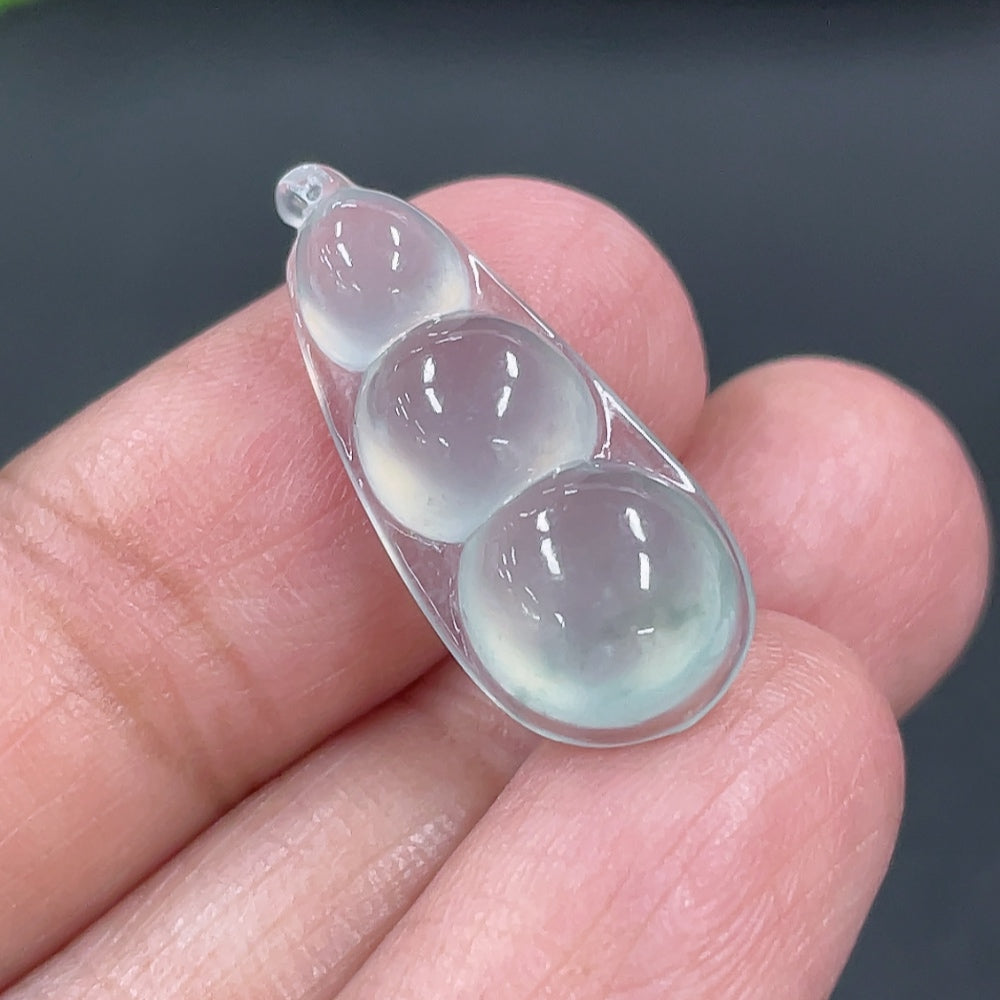 Jadeite auspicious bean inlay piece from HKHQ, weighing approximately 1.88g, showcasing smooth green jade with intricate inlay details.