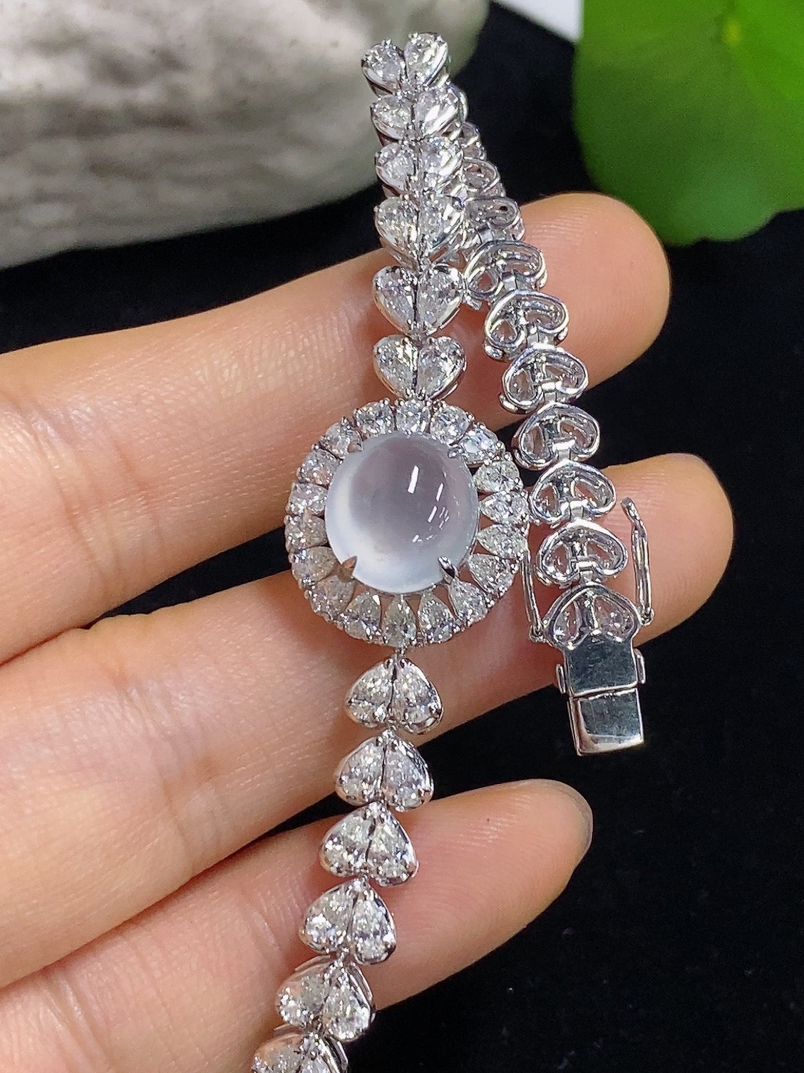 Jadeite cabochon bracelet in 18K gold with diamond accents, featuring a luxurious jewelry design and intricate craftsmanship.
