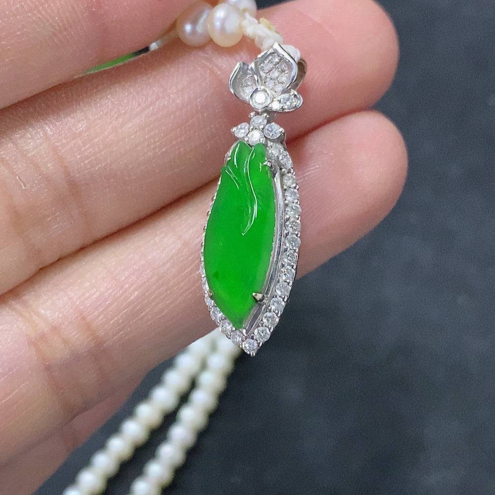 Jadeite freeform inlay pendant with 18K gold accents, displayed on a chain, showing the pendant's smooth, polished surface.
