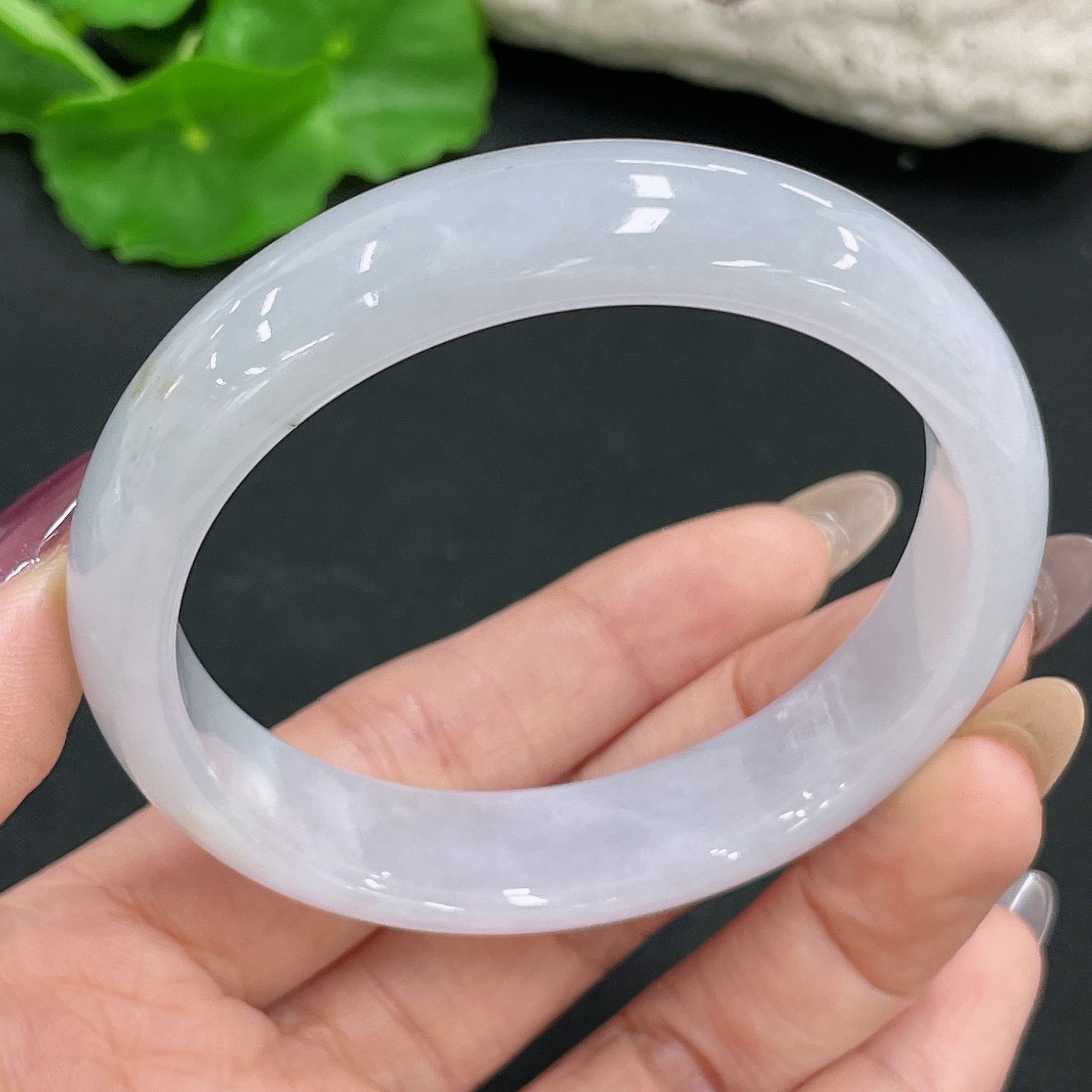 Huiliu Certified Jadeite round bangle showcasing smooth, polished green jade with a glossy finish and traditional craftsmanship.