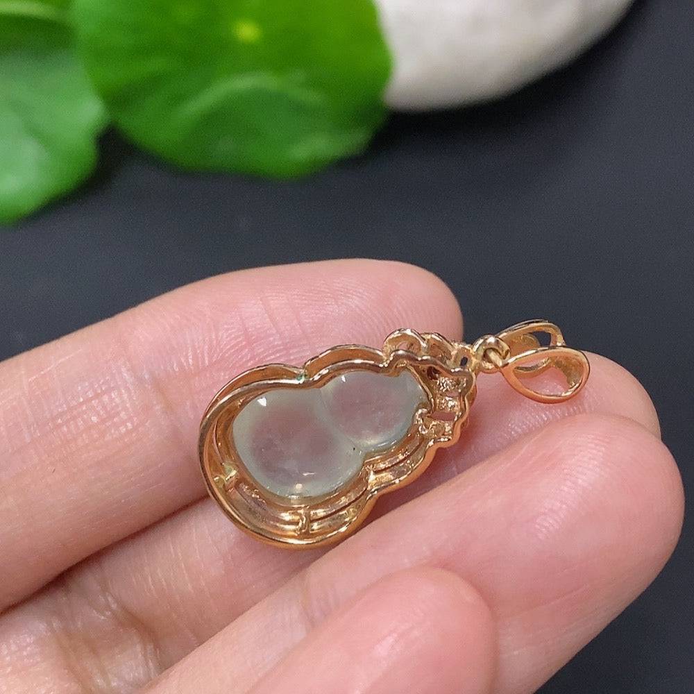 Jadeite inlaid gourd pendant with 18k gold and diamond accents, featuring intricate craftsmanship and a smooth, polished surface.