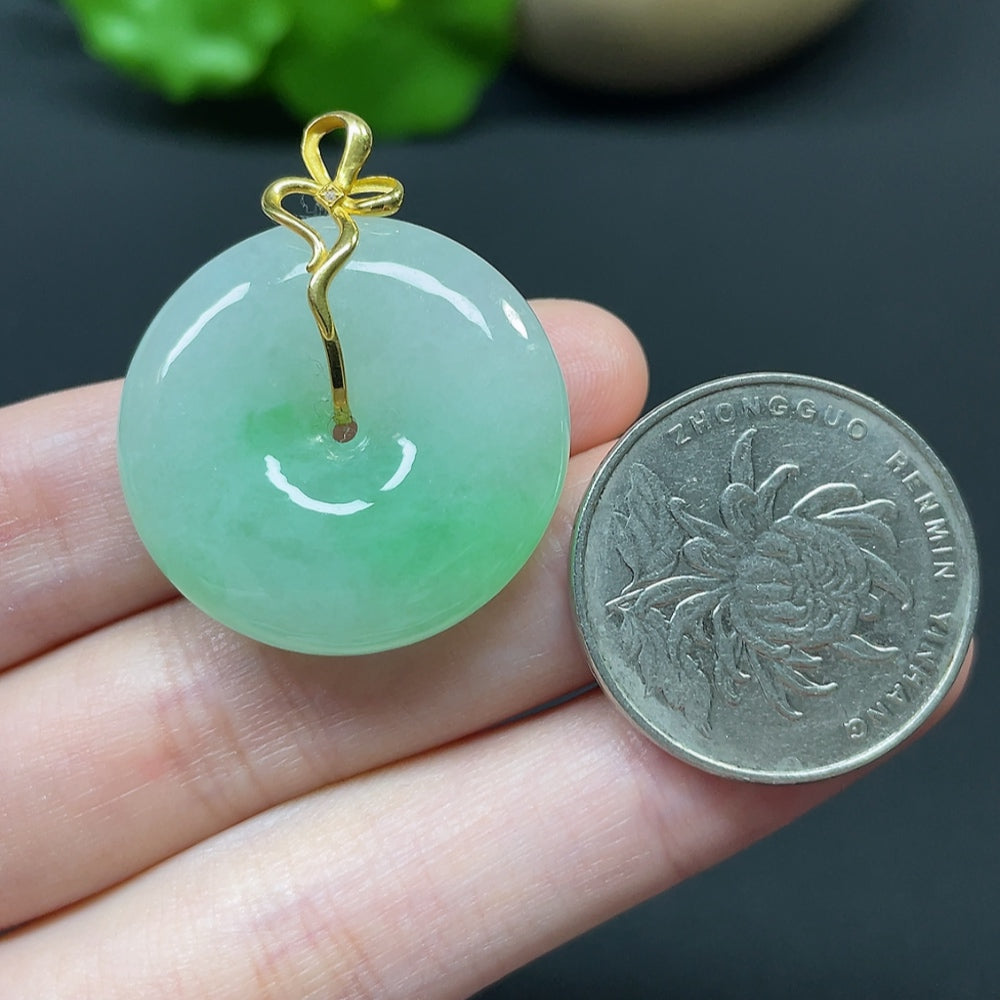 Jadeite Peace Knot pendant in 18k gold with diamond side stones, showcasing intricate inlay and elegant design.