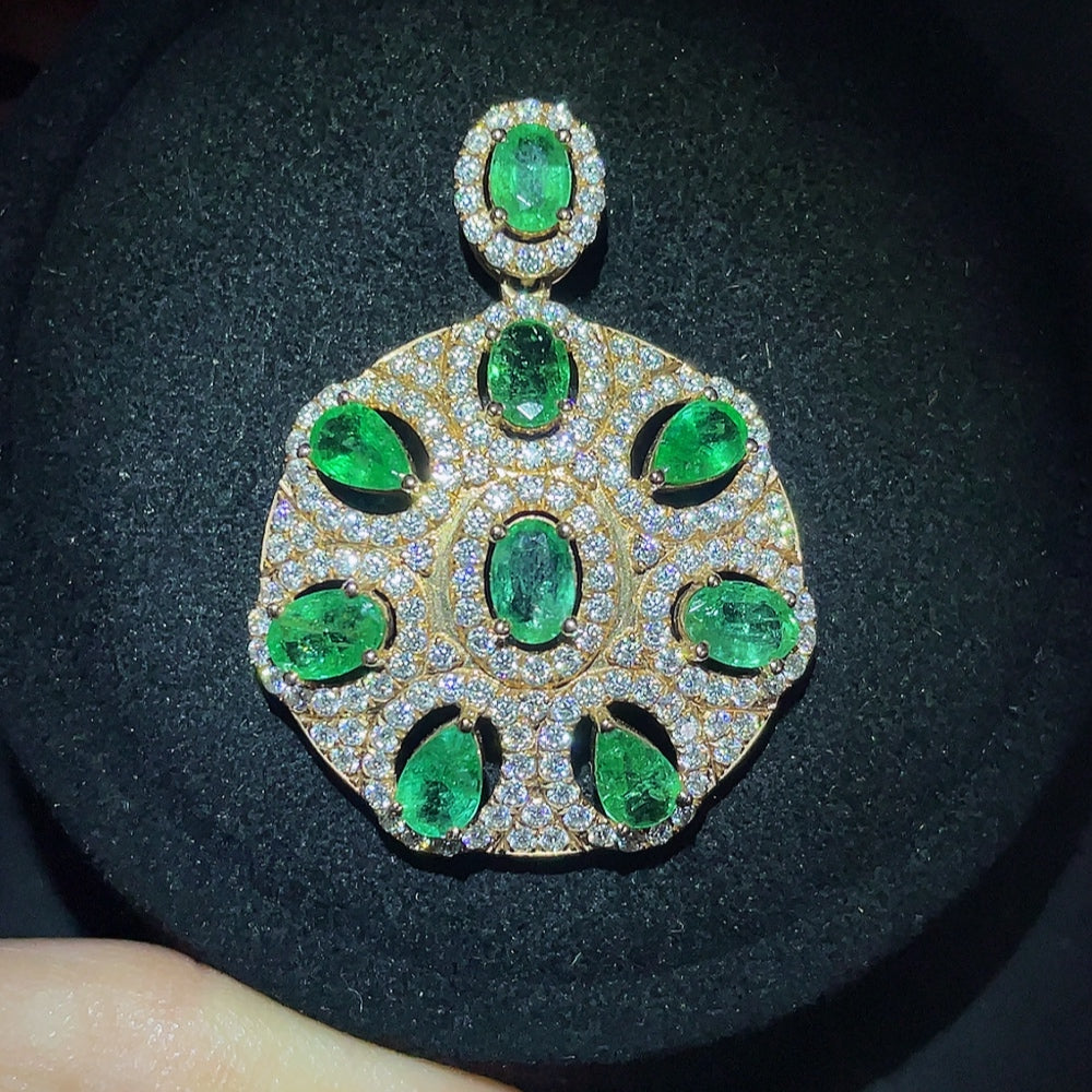 Emerald pendant with 18K gold setting, clarity enhanced, jewelry necklace by HKHQ, showcasing a vibrant green gemstone.