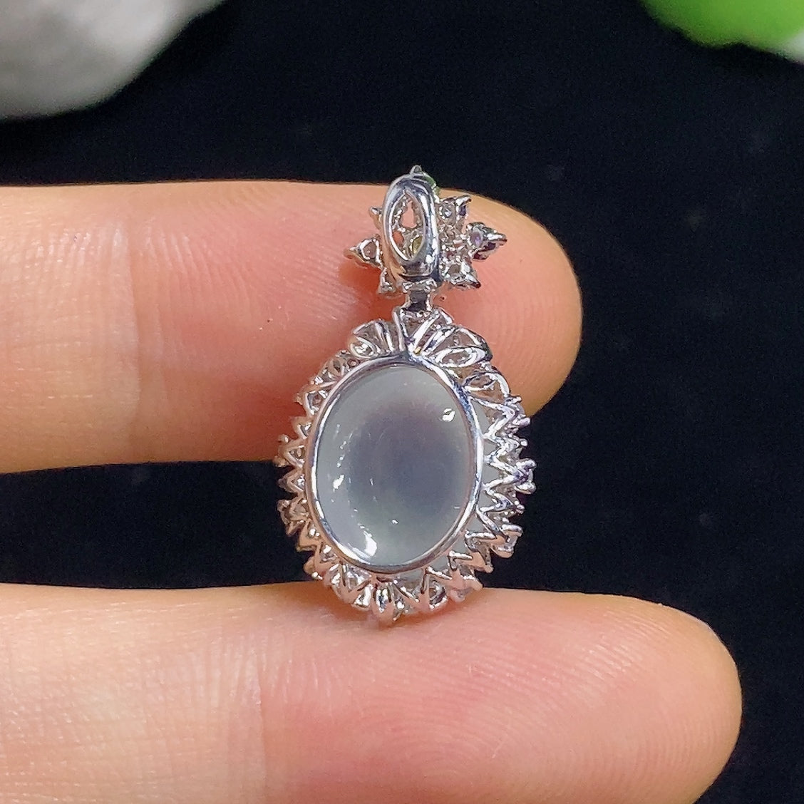 Jadeite pendant with 18K gold and diamond accents, elegant necklace featuring a polished green jadeite stone and fine jewelry details.