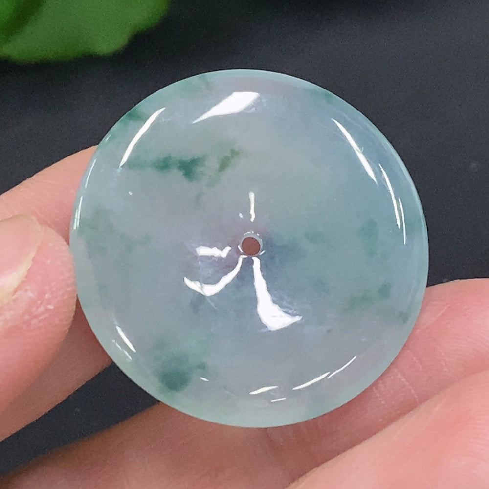 Huiliu Jadeite Peace Knot pendant showing intricate carved design in vibrant green jade, certified by Huiliu HQ