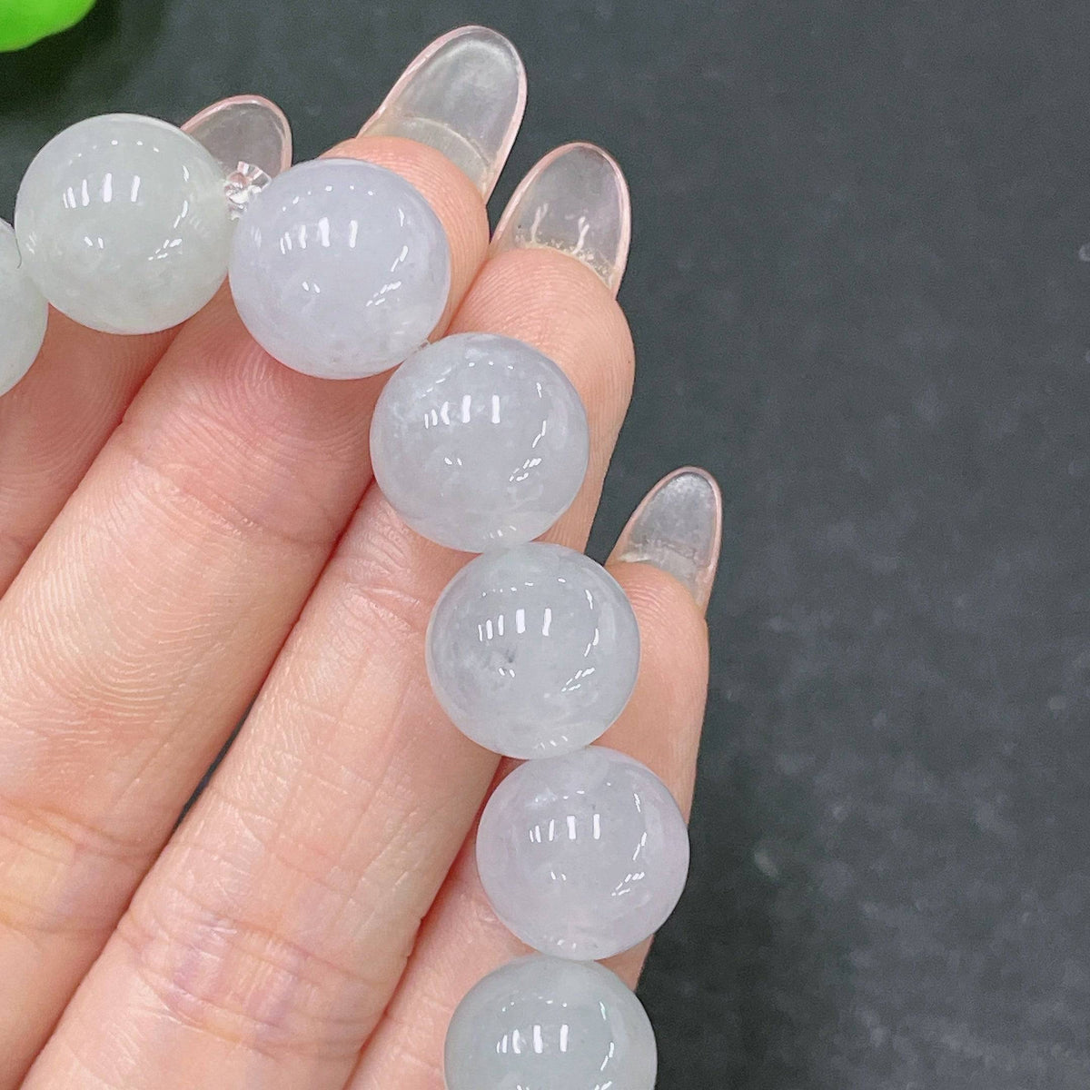 Huiliu certified jadeite bracelet with 12.3mm jade beads, showcasing smooth, polished green jade stone jewelry.