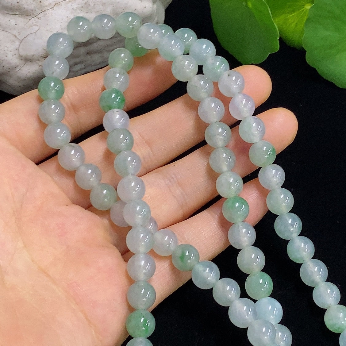 Jadeite Tara pendant made of green jade with detailed carvings, hanging from a gold chain, crafted by HKHQ.