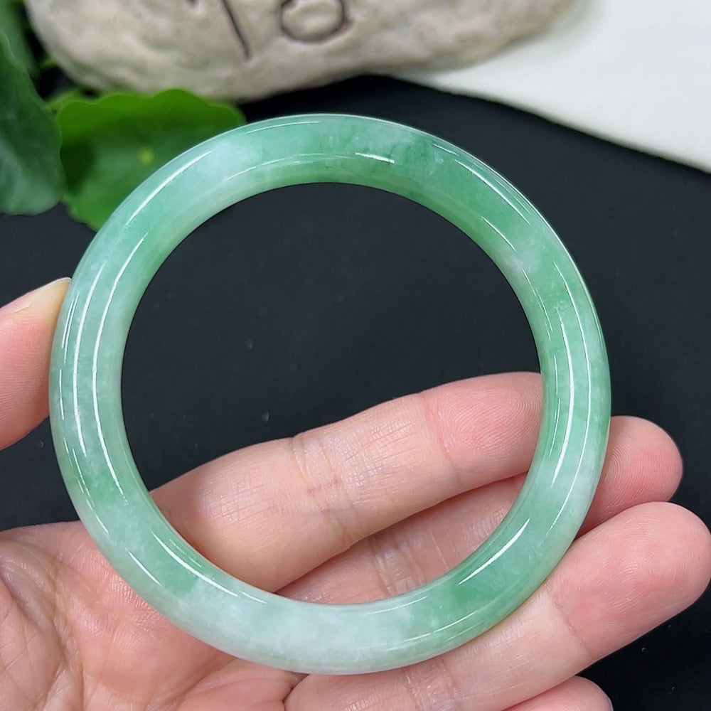 HKHQ Jadeite round bangle in size 56, weighing approximately 43.02g, with smooth, polished jadeite surface.