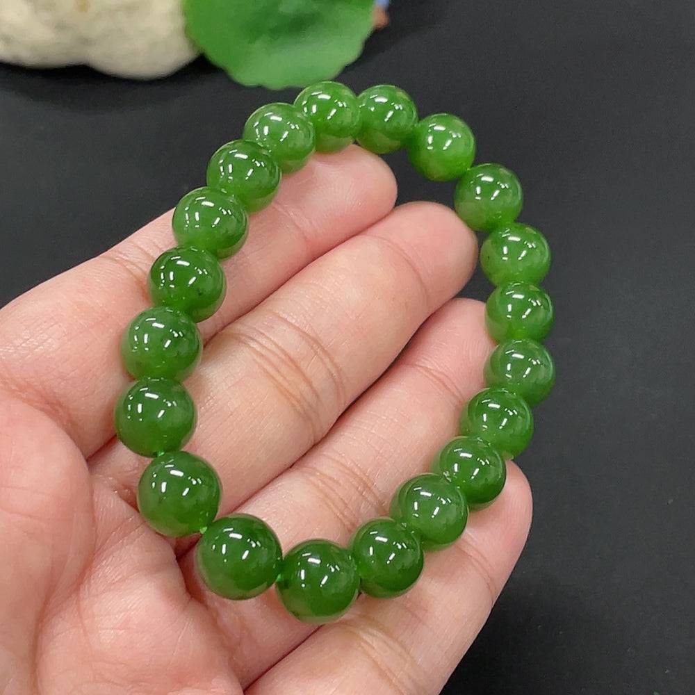 Hetian jade bracelet by HUILIU HQ featuring 9.5mm beads, weighing approximately 28.6 grams, showcasing smooth, polished jade stones.