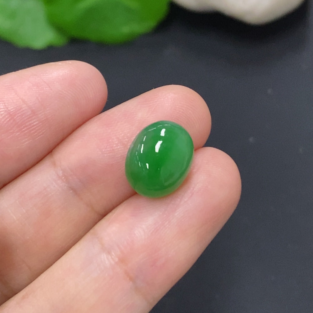 Jadeite cabochon jewelry by HKHQ, approximately 1.1g, showcasing smooth polished green gemstone with a rounded, glossy surface.