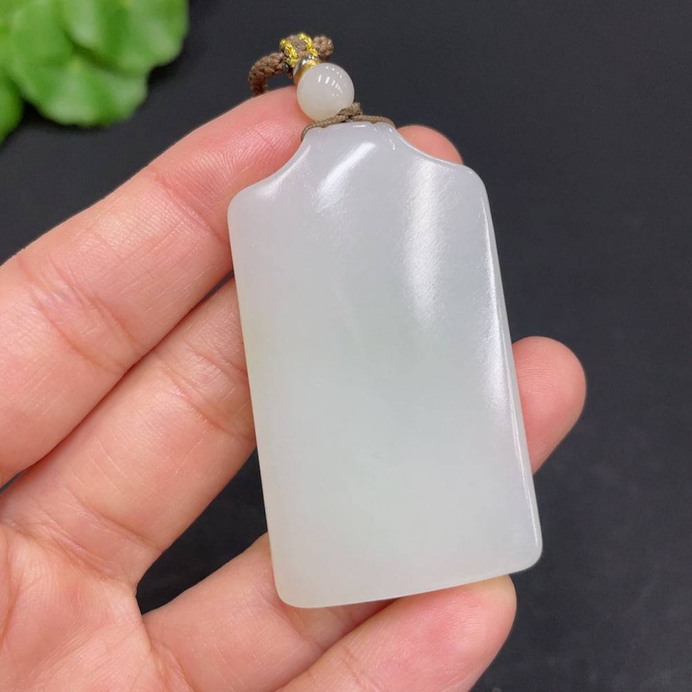 Huiliu certified Hetian jade pendant, plain design, smooth polished surface, showcasing natural green jade color.