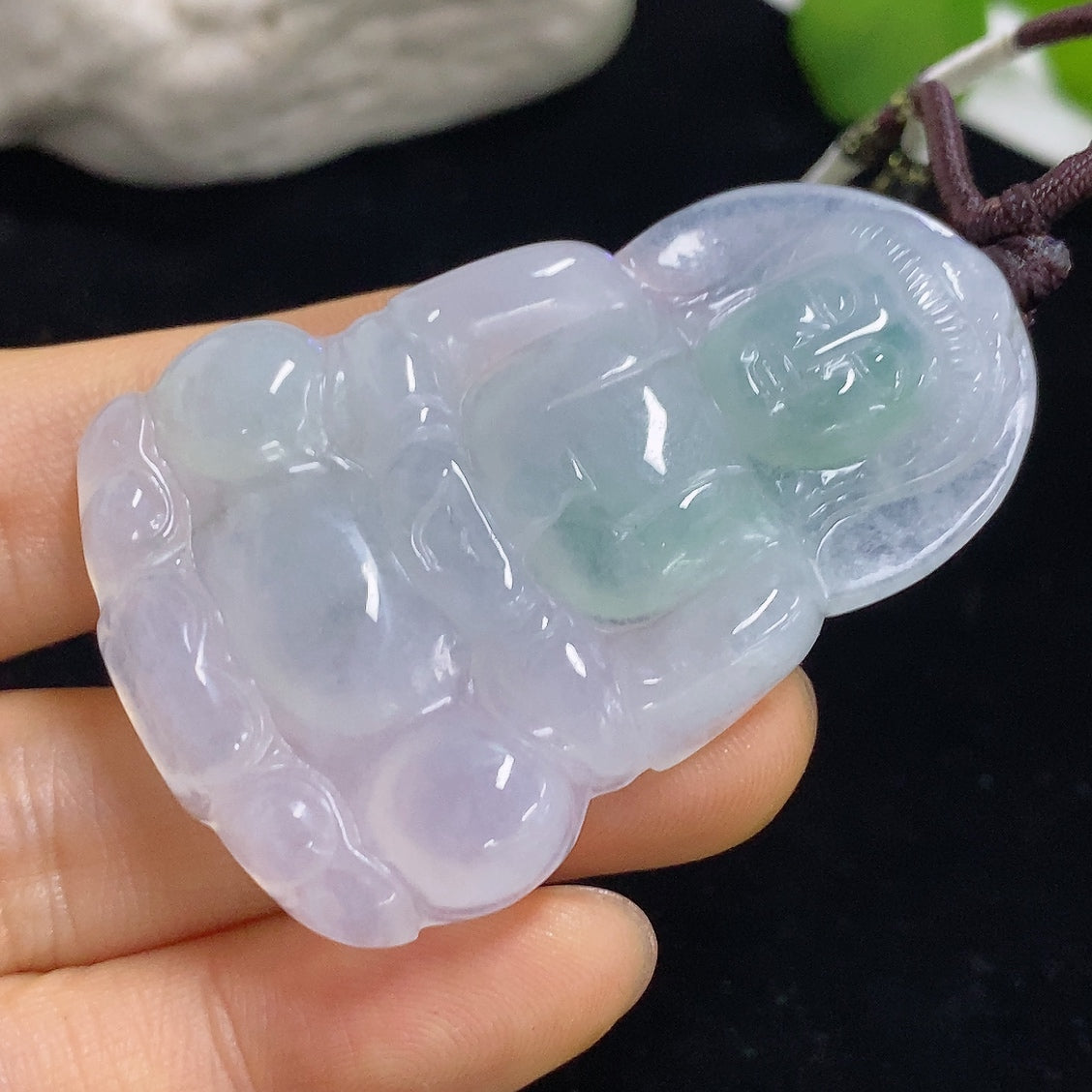 Jadeite Guanyin pendant with a rope, crafted from green jade, weighs approximately 21.6g, featuring detailed religious motif.