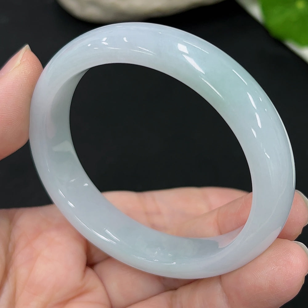 HKHQ Jadeite oval bangle in size 54.6 with a weight of 44.9g, featuring smooth, polished jadeite and a classic oval shape.