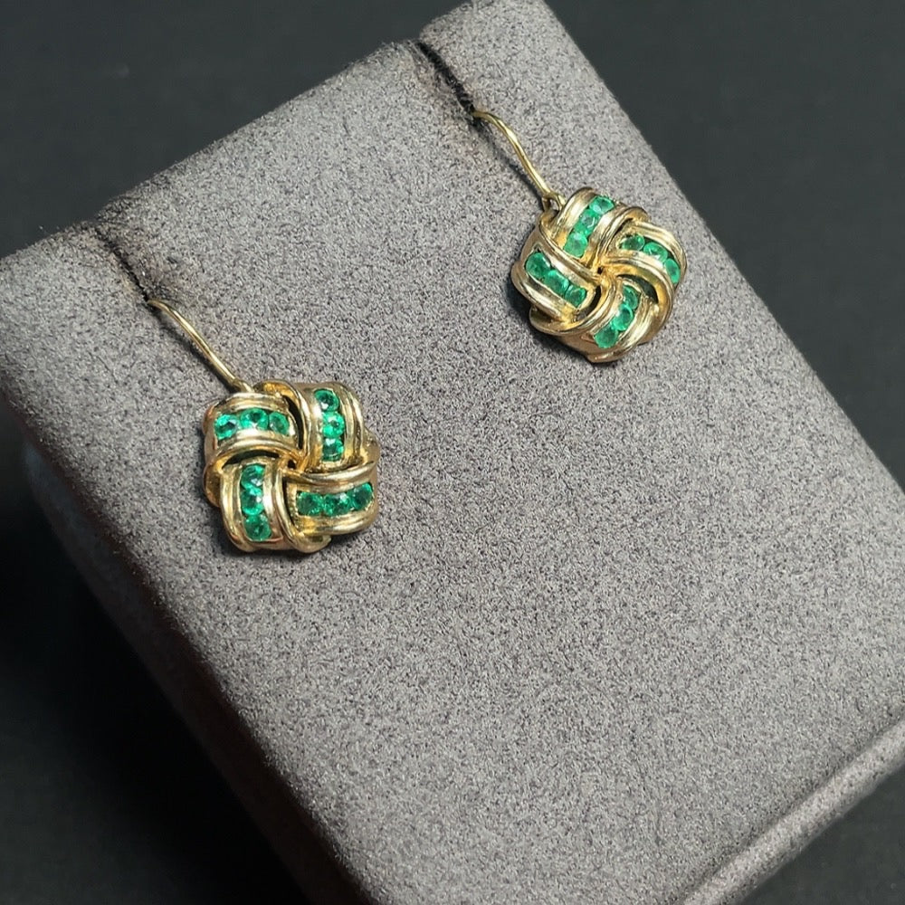 Emerald gemstone earrings with 9K gold setting, clarity enhanced, weighing approximately 4g, featuring detailed gemstone and gold design.