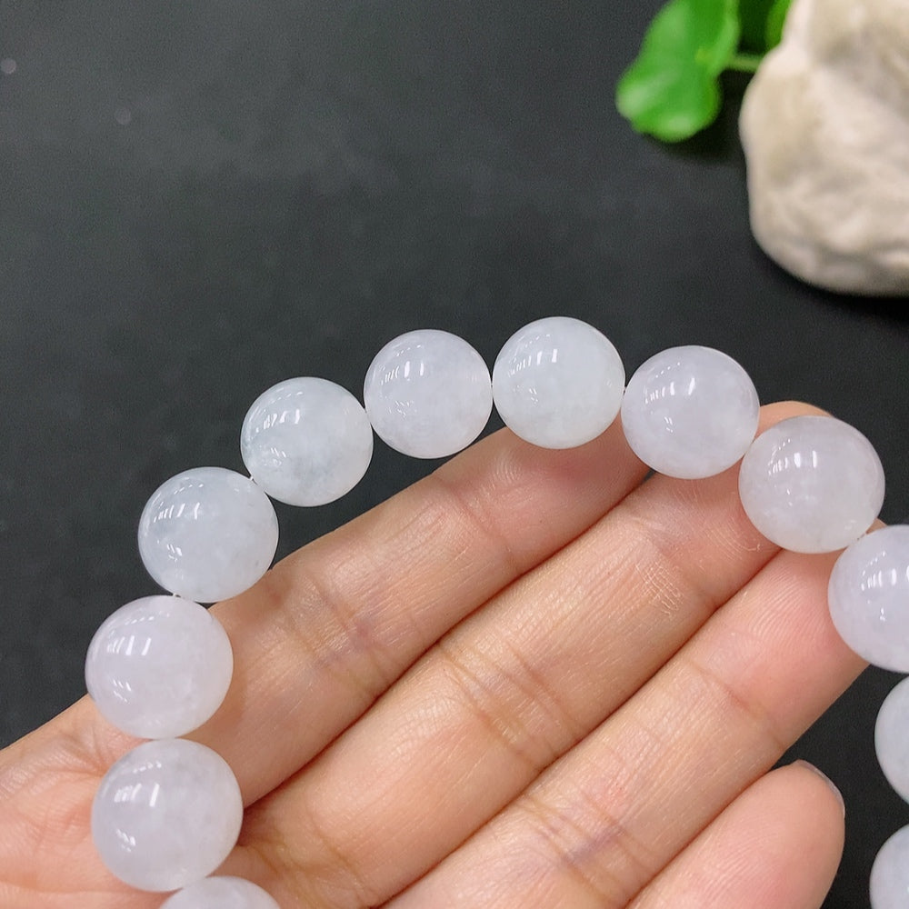 HUILIU HQ jadeite bracelet with 12mm beads, showcasing smooth, polished green jade stones on a white background.