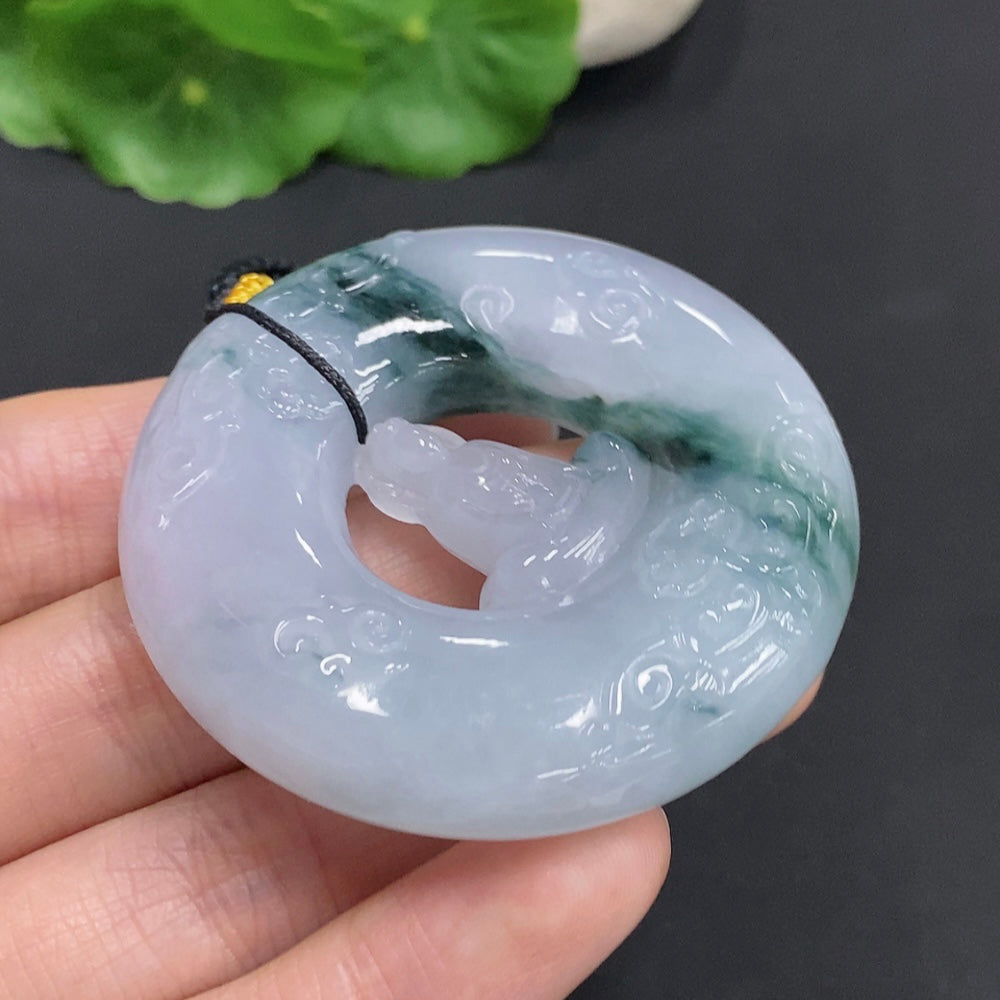 Huiliu Jadeite Enlightenment Pendant featuring vibrant green jade, polished and carved with intricate details, on a cord.