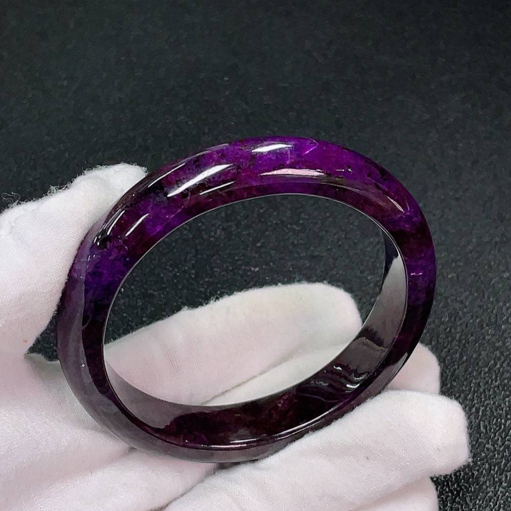 Sugilite gemstone bracelet with purple hues, featuring mineral components, weighing 51.6g and measuring about 57.8mm in size.