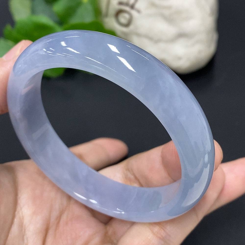 Jadeite round bangle with size 57.3 and weight 56.3g, crafted by HUILIU HQ, showcasing smooth, polished green jade surface.
