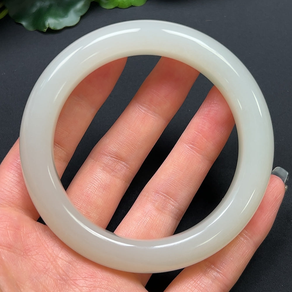 Round Hetian Jade bracelet by HKHQ, 58.9mm diameter, smooth polished surface, weighs approx. 67.83g, showcasing natural jade beauty.