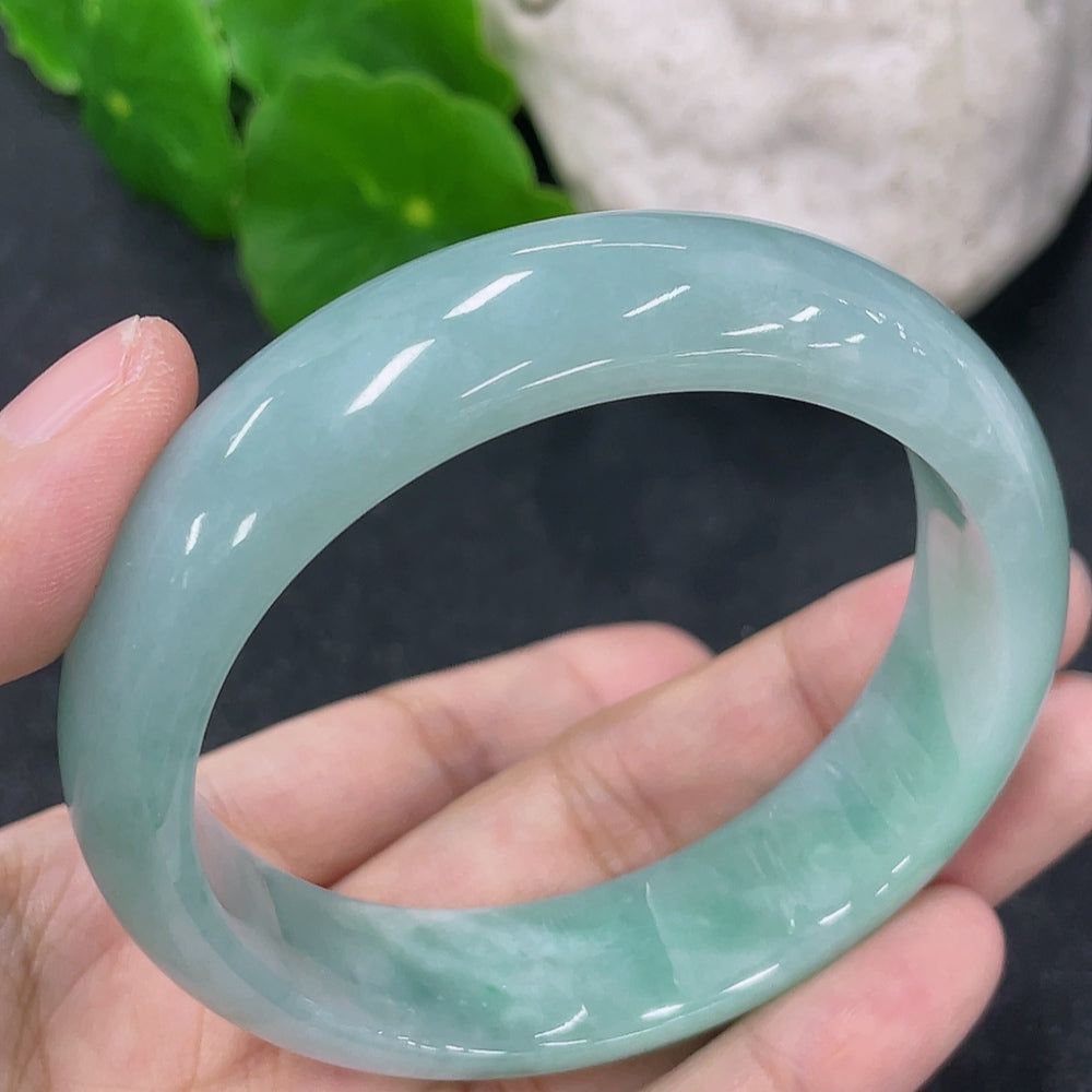 HKHQ jadeite round bangle, size 54.7mm, showing smooth polished surface and vibrant green color, weight 57.3g.