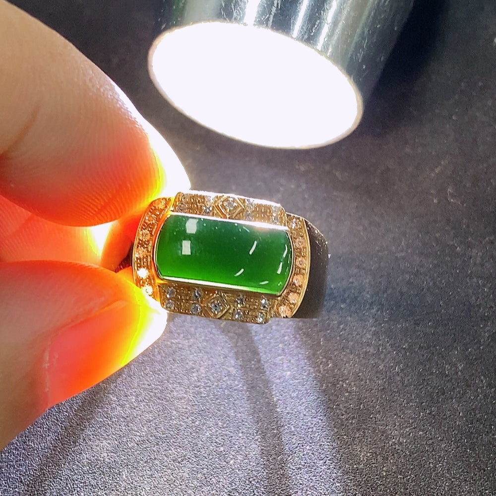 Elegant jadeite and diamond ring in 18K gold with intricate detailing, showcasing luxurious craftsmanship and vibrant gemstones.