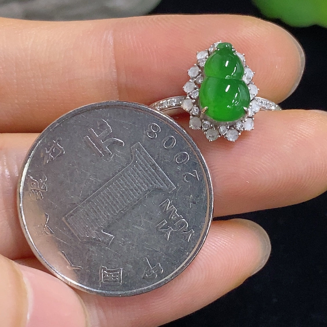 Jadeite gourd inlay ring by HKHQ featuring 18K gold and diamond accents, displayed on a neutral background.