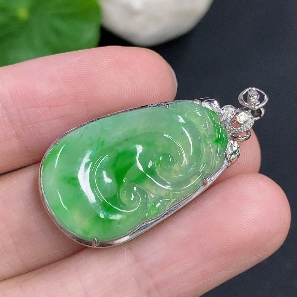 Jadeite Ruyi pendant with 18K gold and diamond accents, showcasing a polished jade piece with intricate detailing.